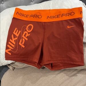 Nike Women's Athletic Shorts in Orange and Red
